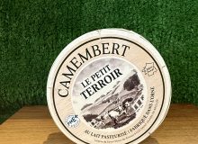 A picture of a boxed Camembert Le Petit Terroir. It is on a wooden board with a green background